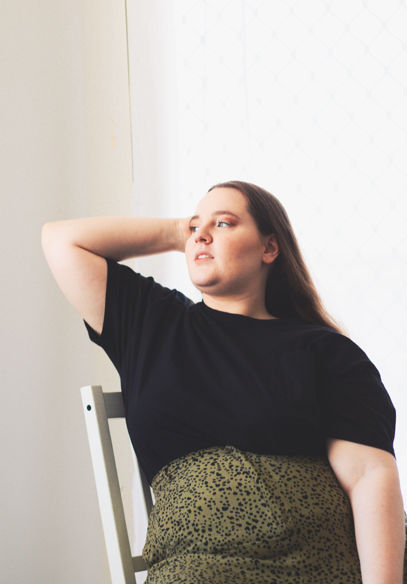 Photo of Sarah posing in a chair.